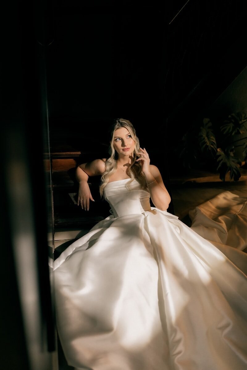 Elegant woman in white wedding dress with dramatic lighting